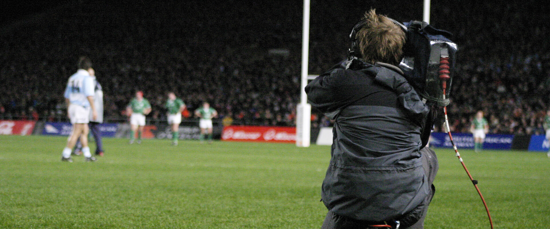 Camera operator capture a rugby match.